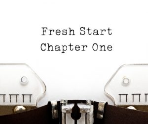 Old style typewriter image, up close showing area where typewriter ribbon is close to paper. Words typed on paper read: “Fresh Start, Chapter One” typed on page. Image by IvelinRadkov (iStock). Used for Fear of Change – Responding to Change.